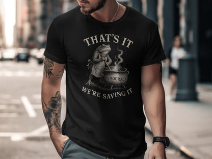 Black t-shirt with frog stirring pot, text reads "That's it, we're saving it."