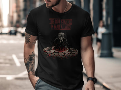 Black t-shirt with graphic of Trump rising from cracked ground with text "THE ROT STARTED IN MAR-A-LAGO".