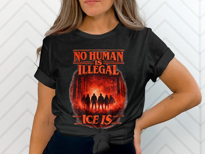 Black t-shirt with "NO HUMAN IS ILLEGAL" and forest silhouette.