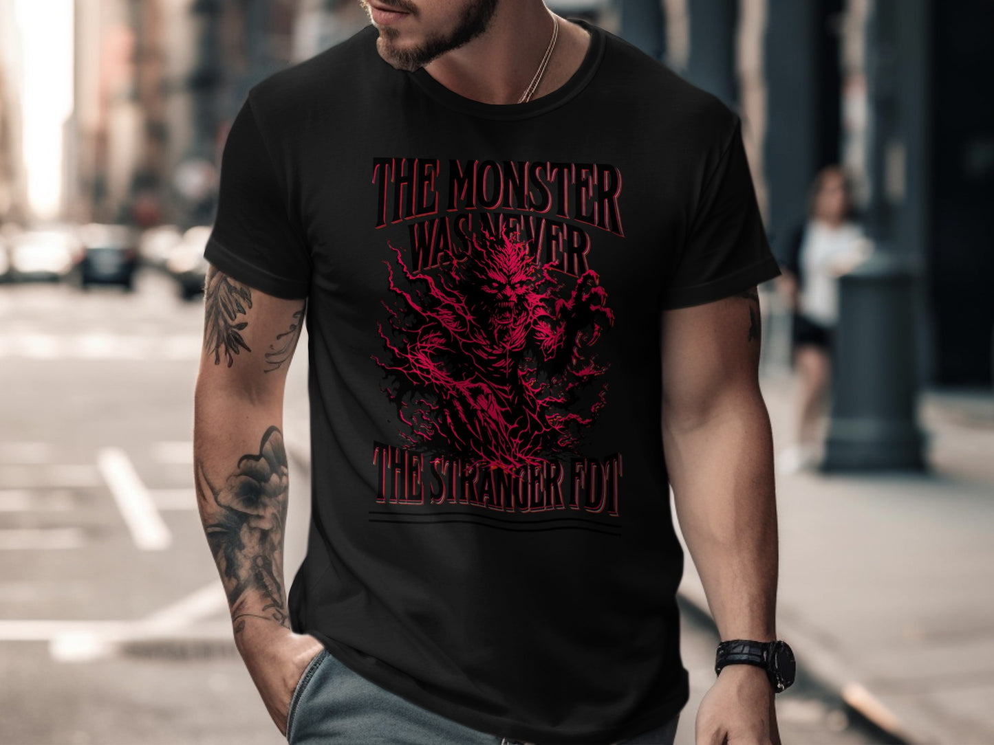 Black t-shirt with red graphic text "The Monster Was Never The Stranger Fuy".