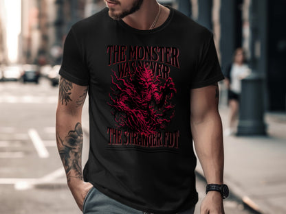 Black t-shirt with red graphic text "The Monster Was Never The Stranger Fuy".