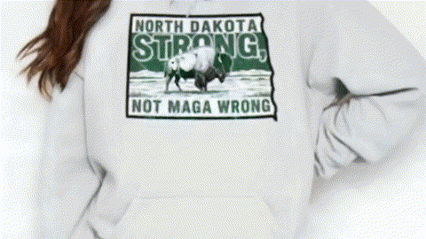 A person wearing a white hoodie with a graphic design featuring a buffalo and the text "North Dakota Strong, Not Maga Wrong".