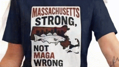 a person wearing a blue t-shirt with a graphic design that includes a fish and the text "Massachusetts Strong, Not MAGA Wrong".