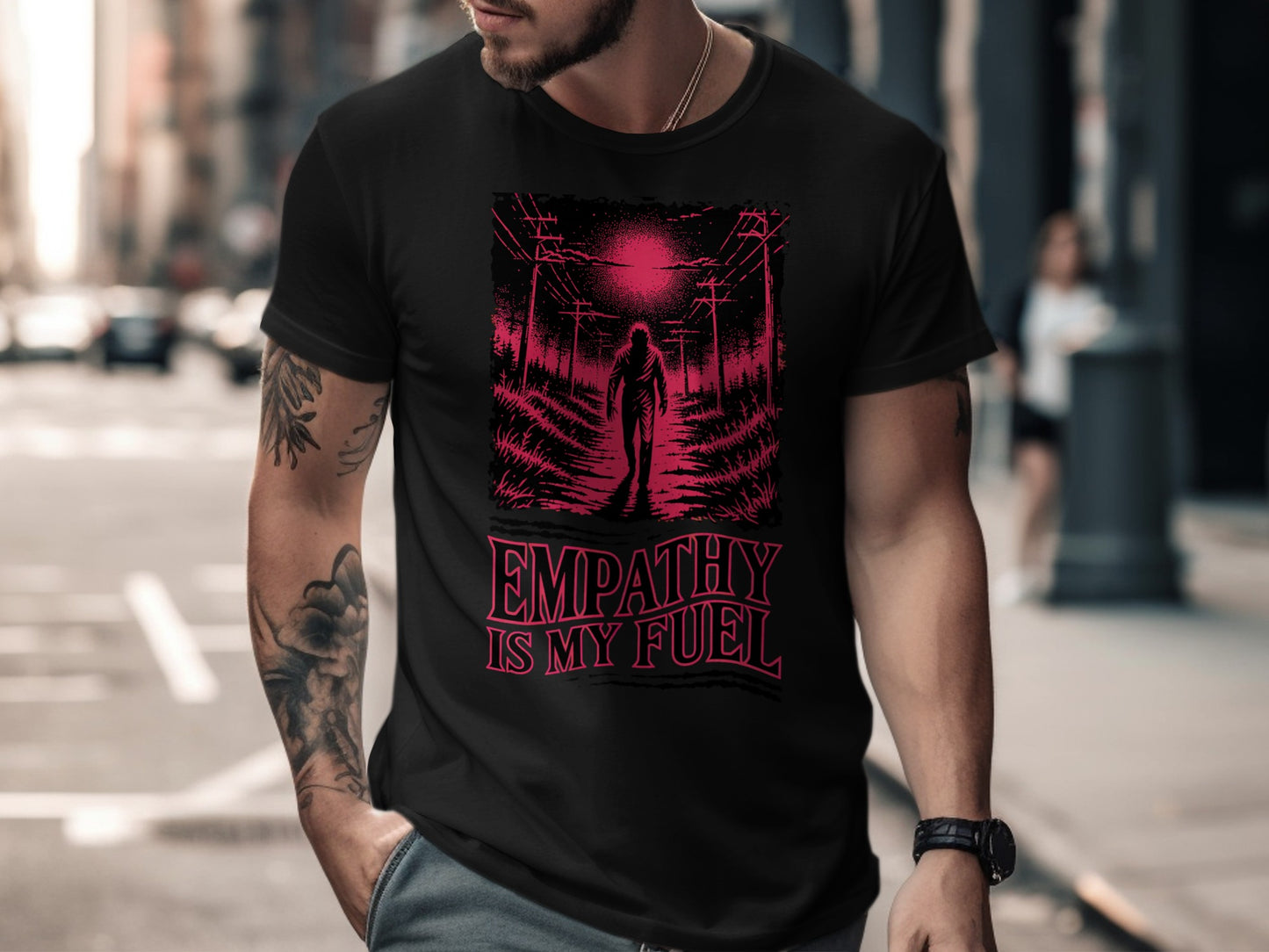 Black t-shirt with "EMPATHY IS MY FUEL" text and a graphic of a figure walking toward power lines.