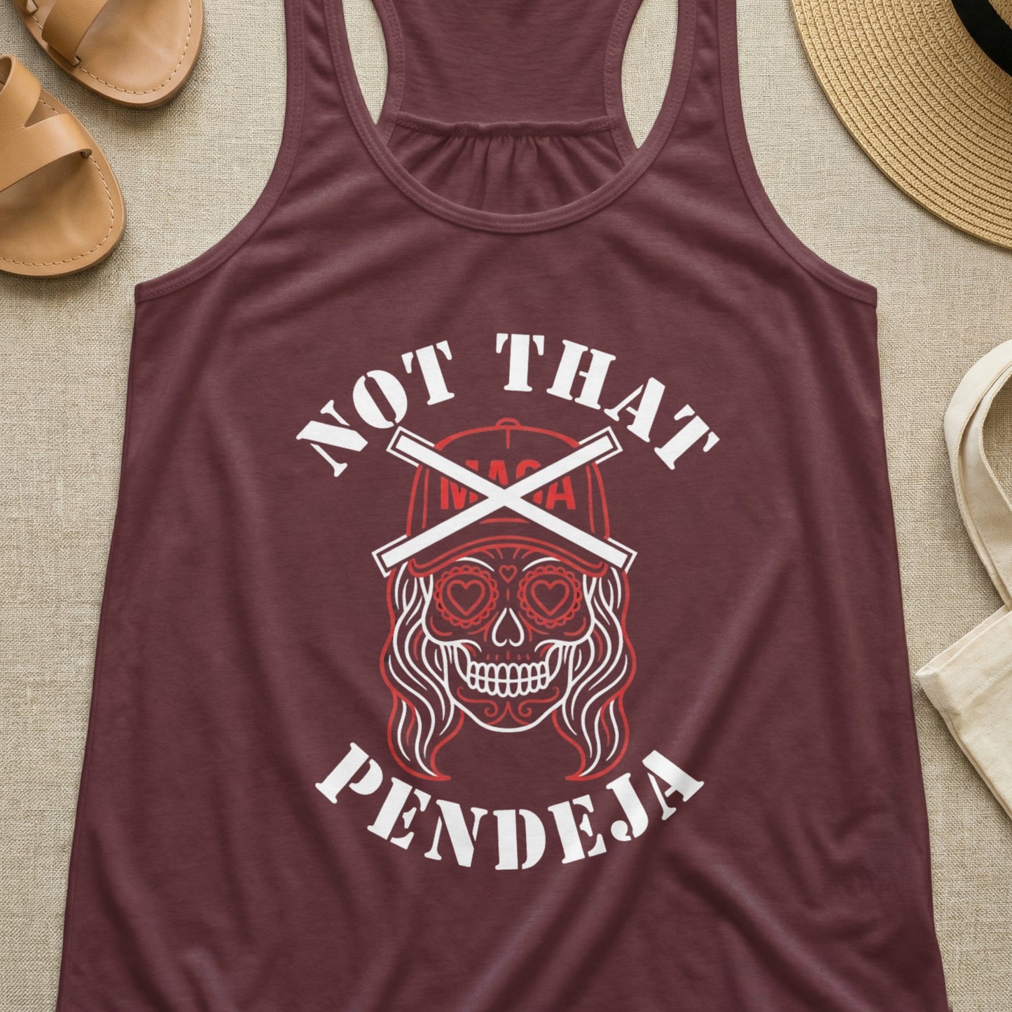 Burgundy tank top with sugar skull graphic and "NOT THAT PENDEJA" text.
