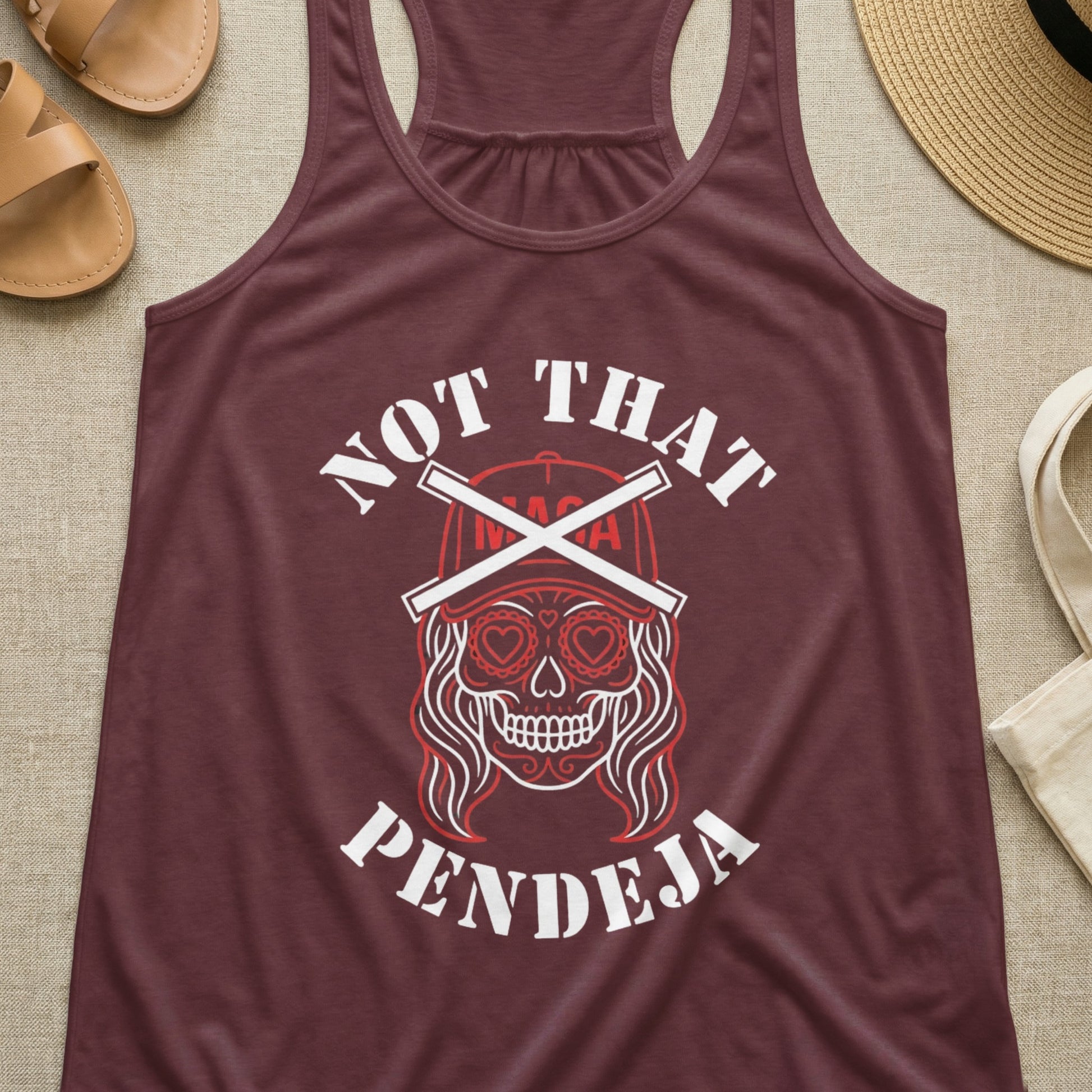 Burgundy tank top with sugar skull graphic and "NOT THAT PENDEJA" text.