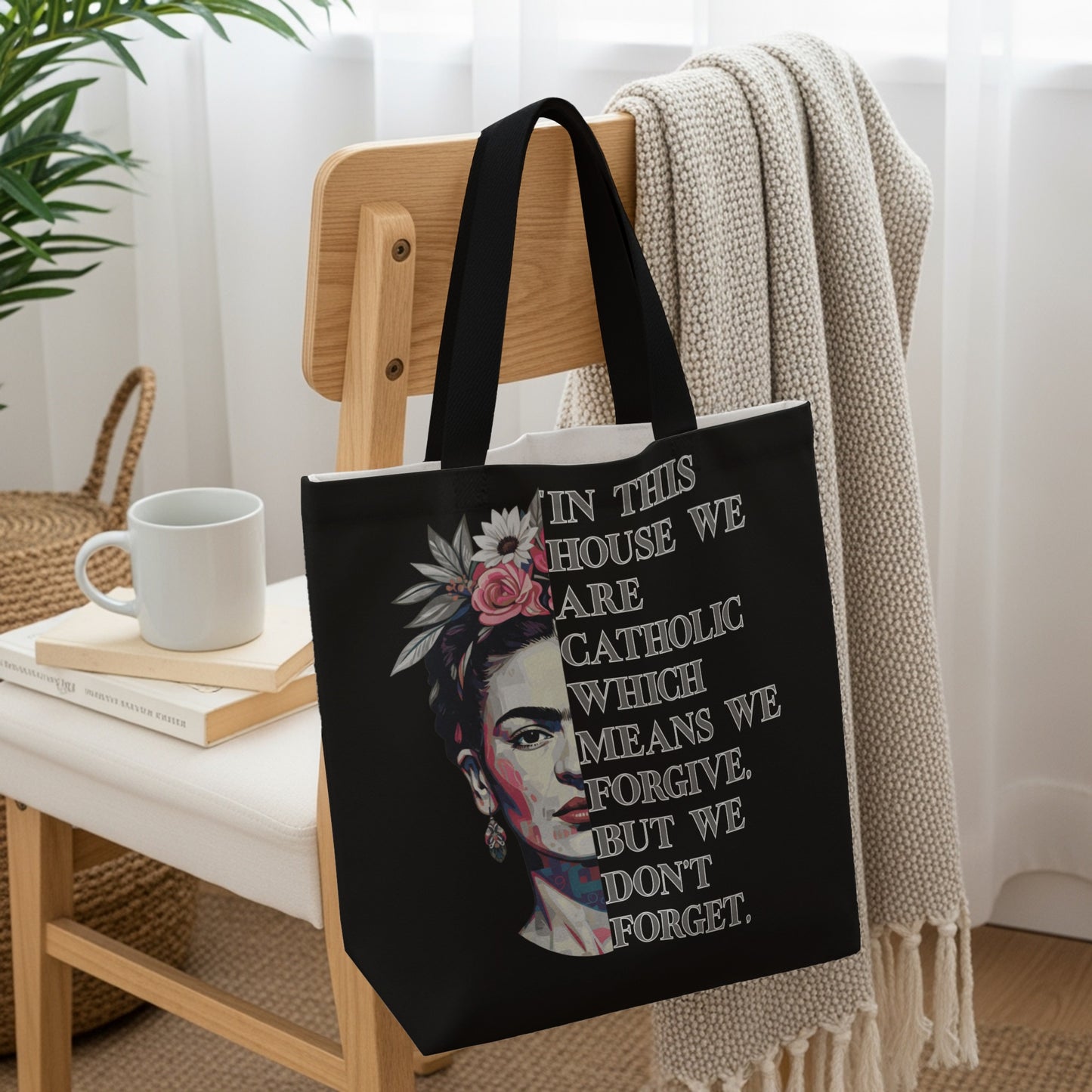 Tote bag with a Frida Kahlo portrait and "In this house we are Catholic, which means we forgive, but we don't forget" text.