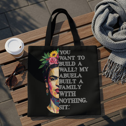 Black tote bag with Frida Kahlo portrait and quote "You want to build a wall? My abuela built a family with nothing. Sit."
