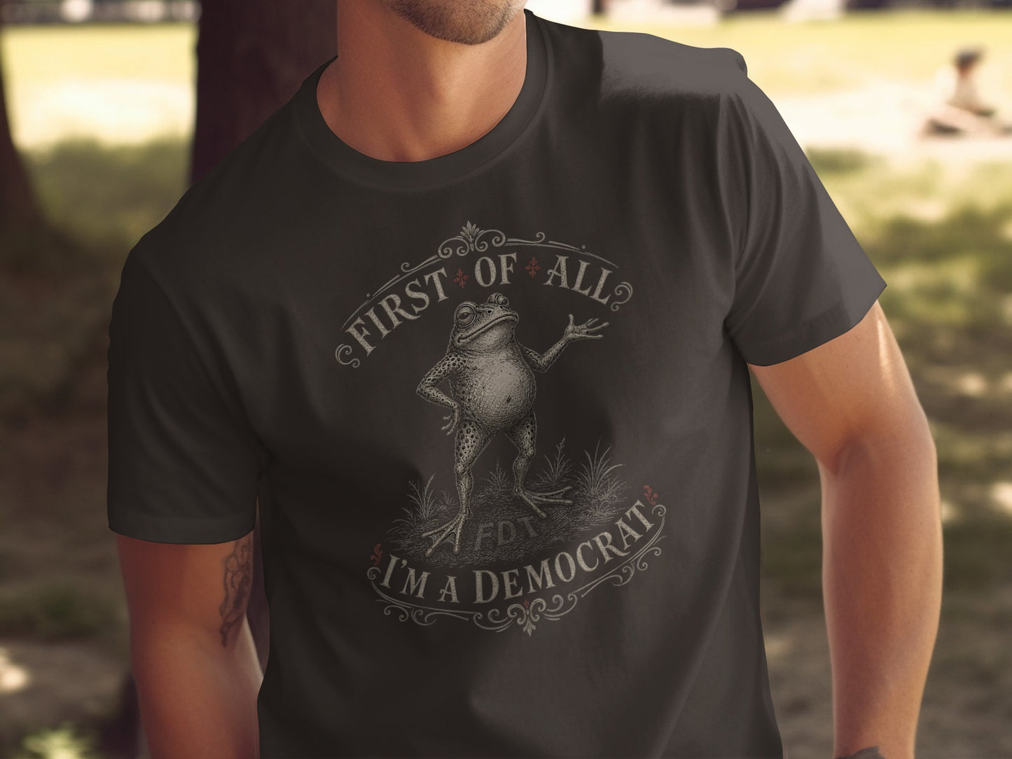 T-shirt with a vintage-style frog illustration and text "First of all, I'm a Democrat".