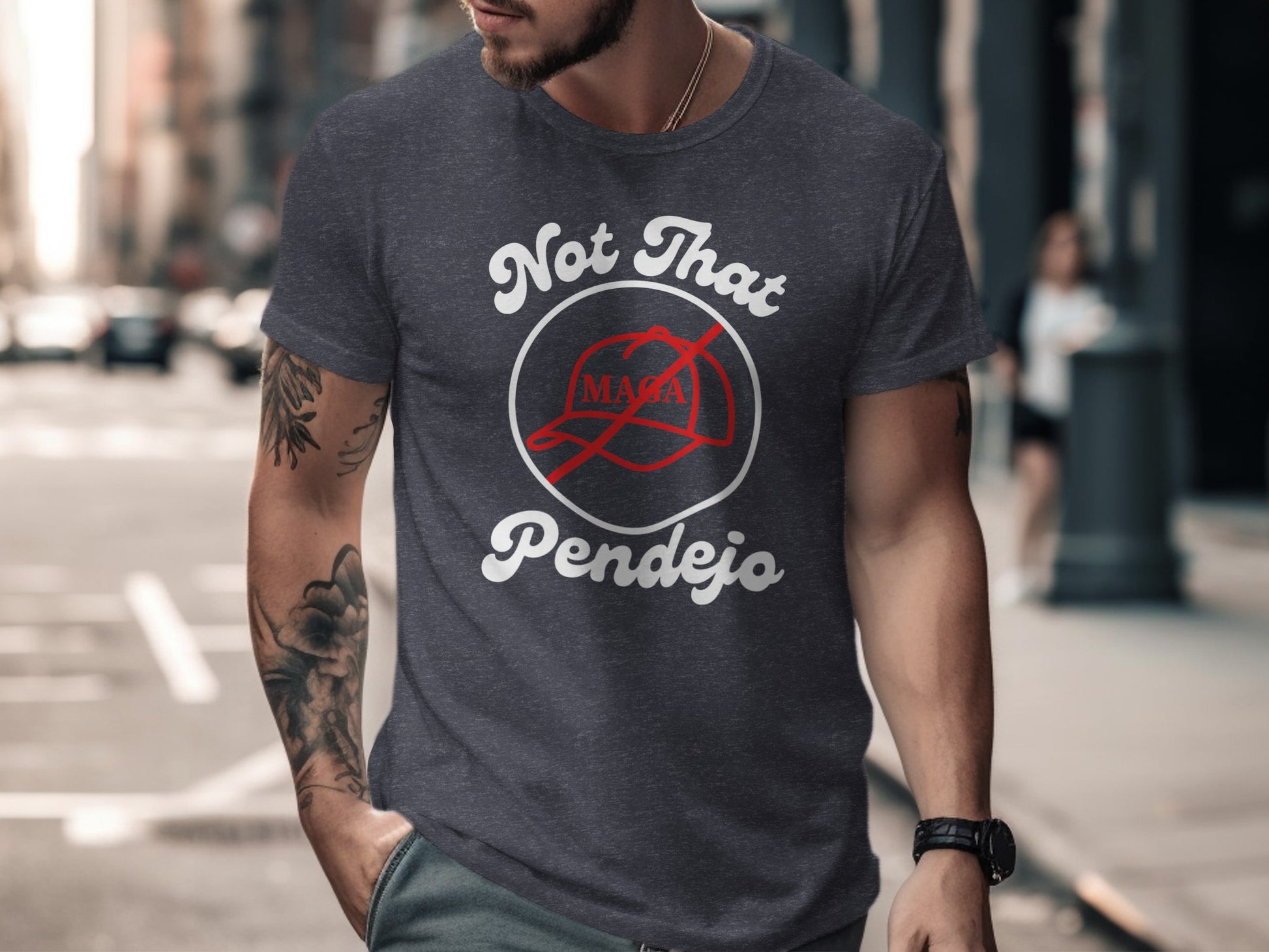 Dark t-shirt with white text "Not That Pendejo" and a red MAGA hat logo.