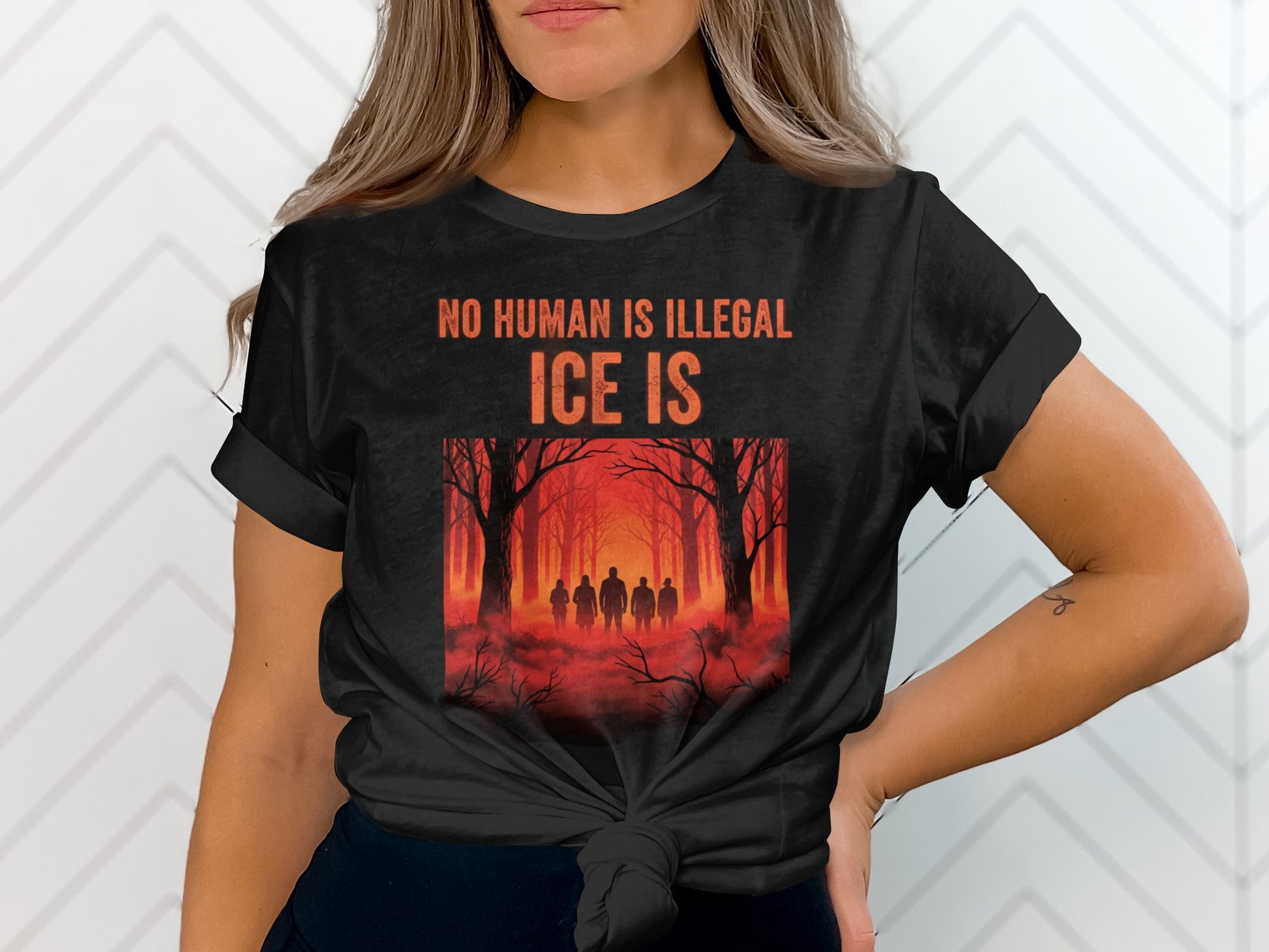 Black t-shirt with "NO HUMAN IS ILLEGAL ICE IS" and forest scene.