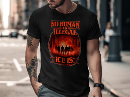 Black t-shirt with "NO HUMAN IS ILLEGAL" text and a forest silhouette.