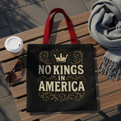 Black tote bag with "NO KINGS IN AMERICA" text and crown design.
