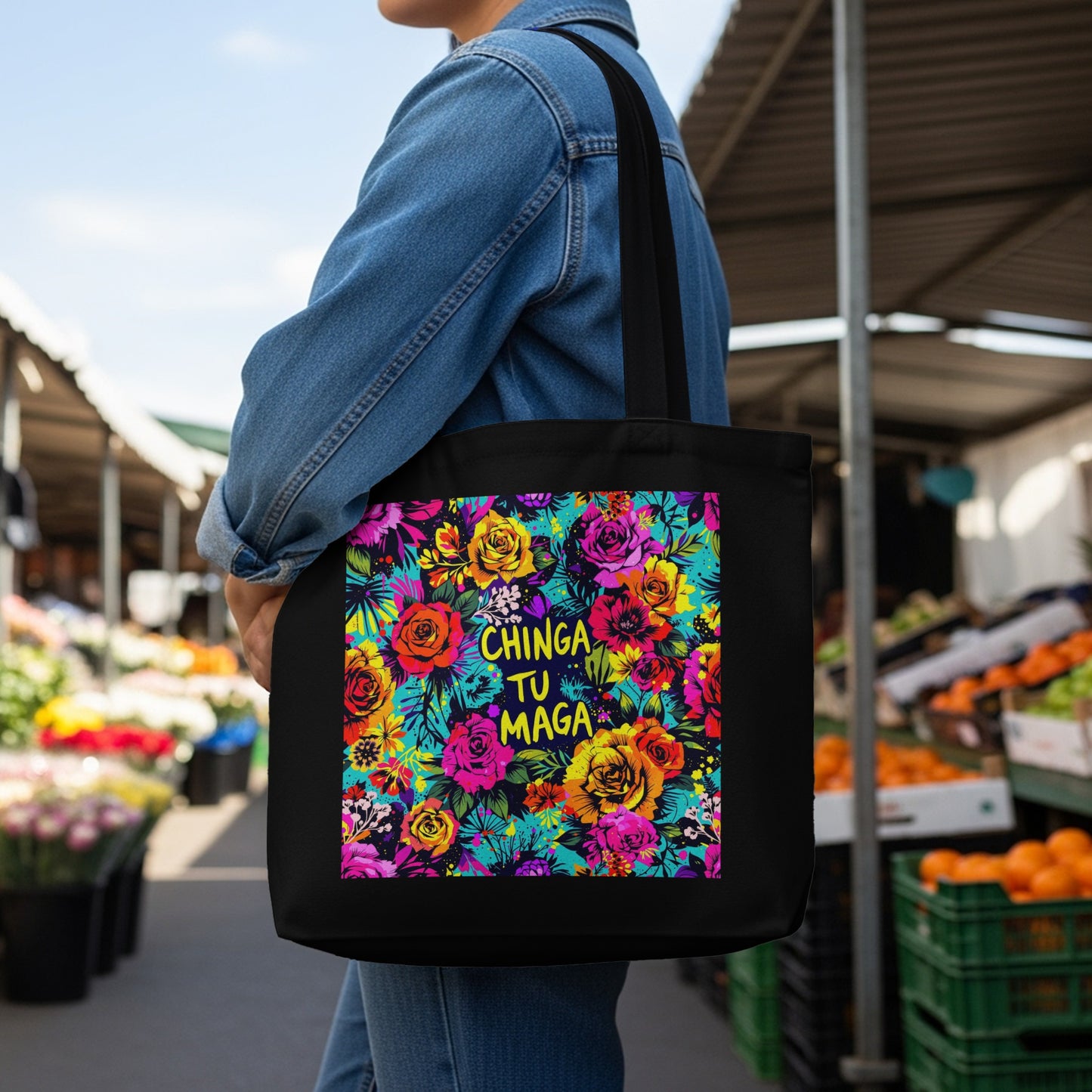 Black tote bag with vibrant floral pattern and "CHINGA TU MAGA" text.