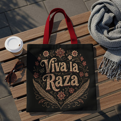 Black tote bag with "Viva la Raza" text and floral design.