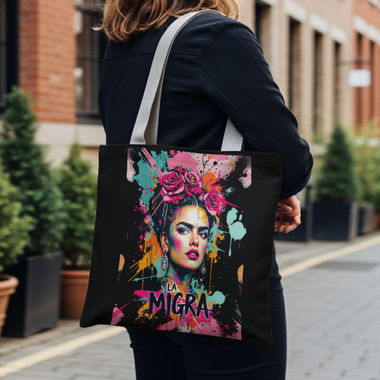 Tote bag with a vibrant Frida Kahlo-inspired portrait and "LA MIGRA" text.