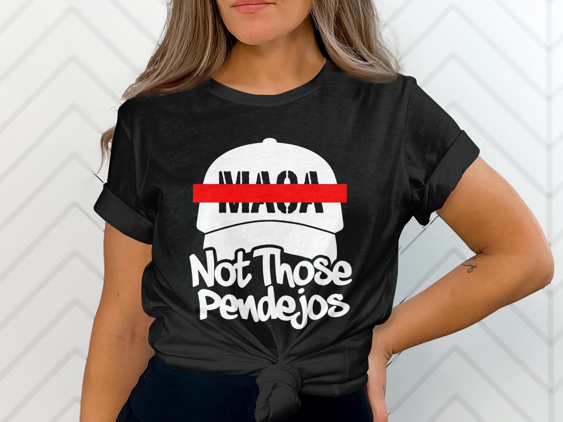 Black t-shirt with white text and a white baseball cap graphic that reads "Not Those Pendejos".