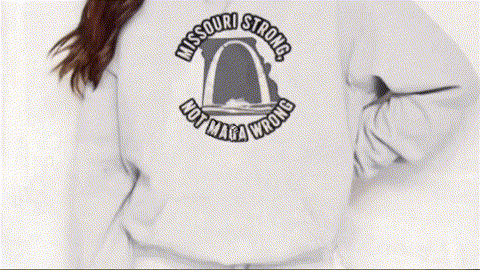 A person wearing a white sweatshirt with a graphic design on the back.