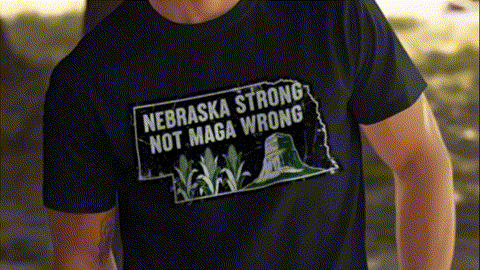 A black t-shirt with a graphic design that says "NEBRASKA STRONG NOT MAGA WRONG" printed on it.