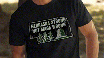A black t-shirt with a graphic design that says "NEBRASKA STRONG NOT MAGA WRONG" printed on it.