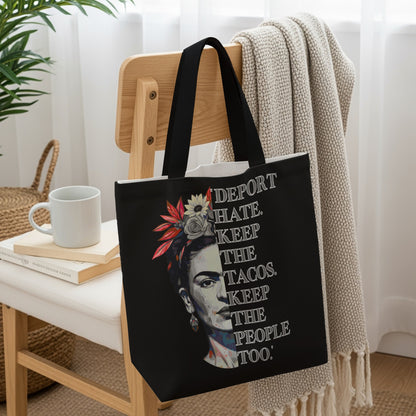 Black tote bag with Frida Kahlo portrait and "DEPORT HATE. KEEP THE TACOS. THE PEOPLE TOO." text.