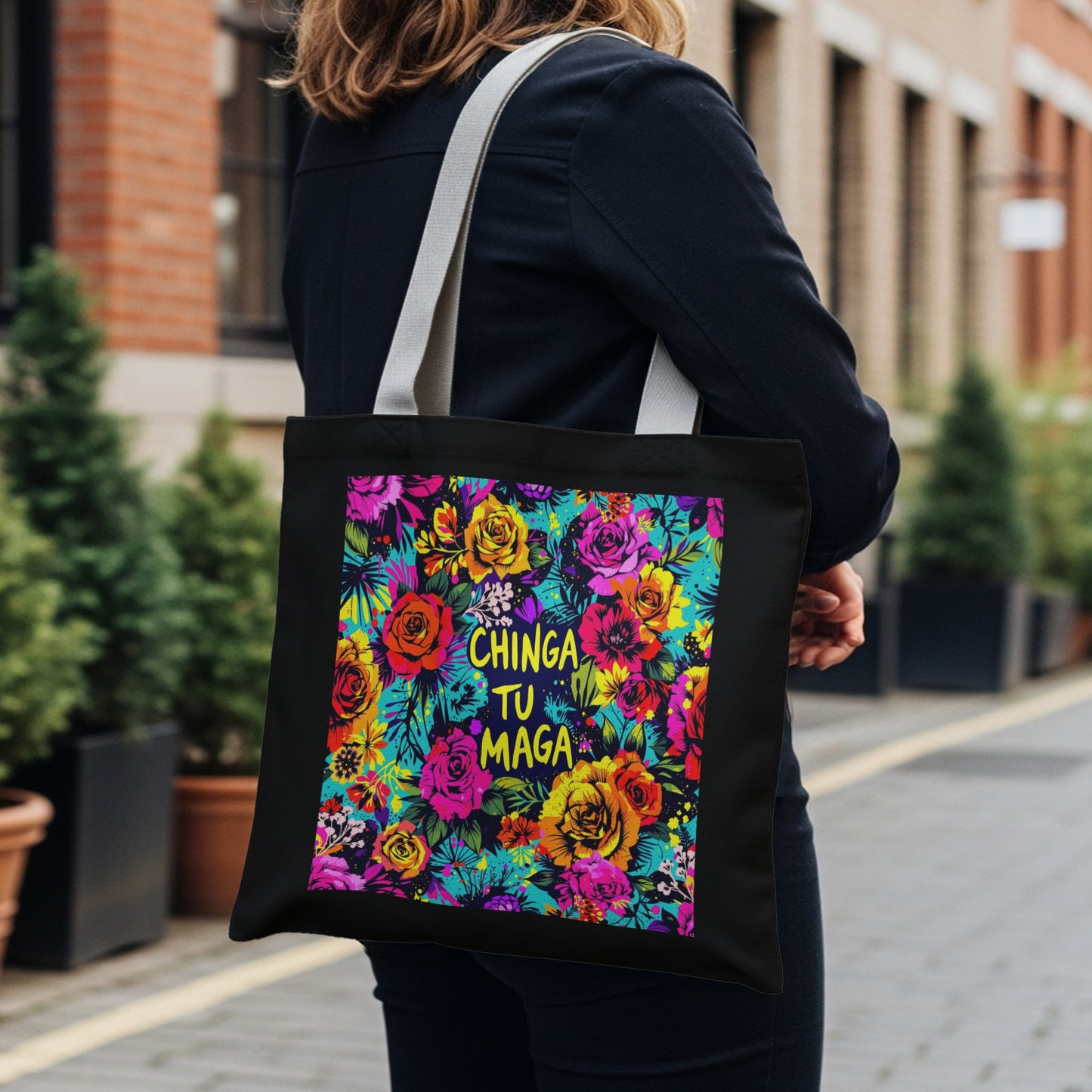 Black tote bag with colorful floral pattern and text "CHINGA TU MAGA".