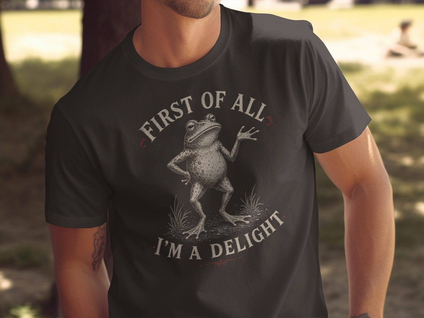 Dark t-shirt with text "First of all, I'm a delight" and frog graphic.