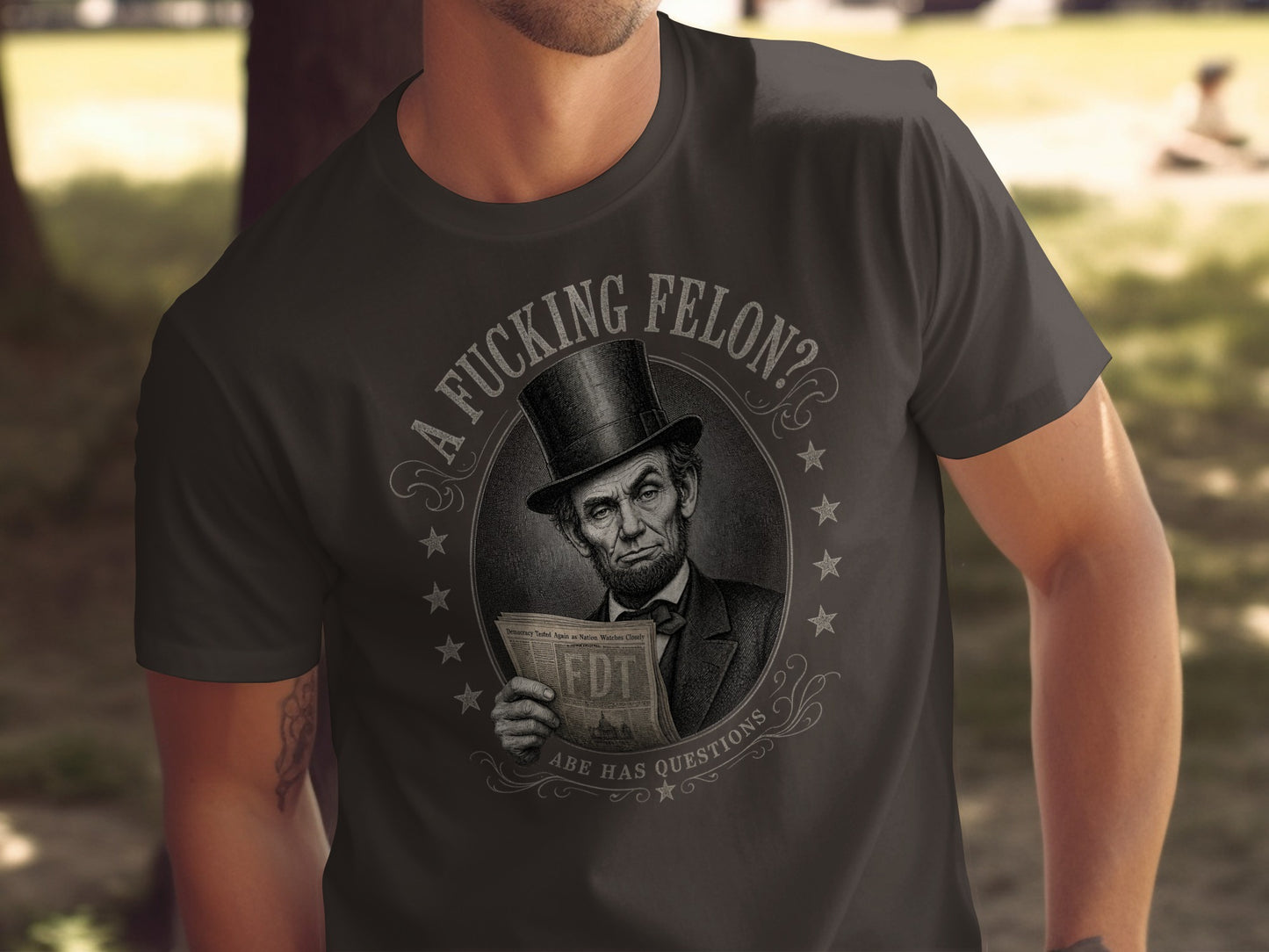 T-shirt with Abraham Lincoln wearing a top hat, holding a newspaper that reads FDT.