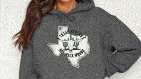A woman wearing a grey hoodie with a graphic design on it.