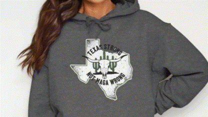 A woman wearing a grey hoodie with a graphic design on it.