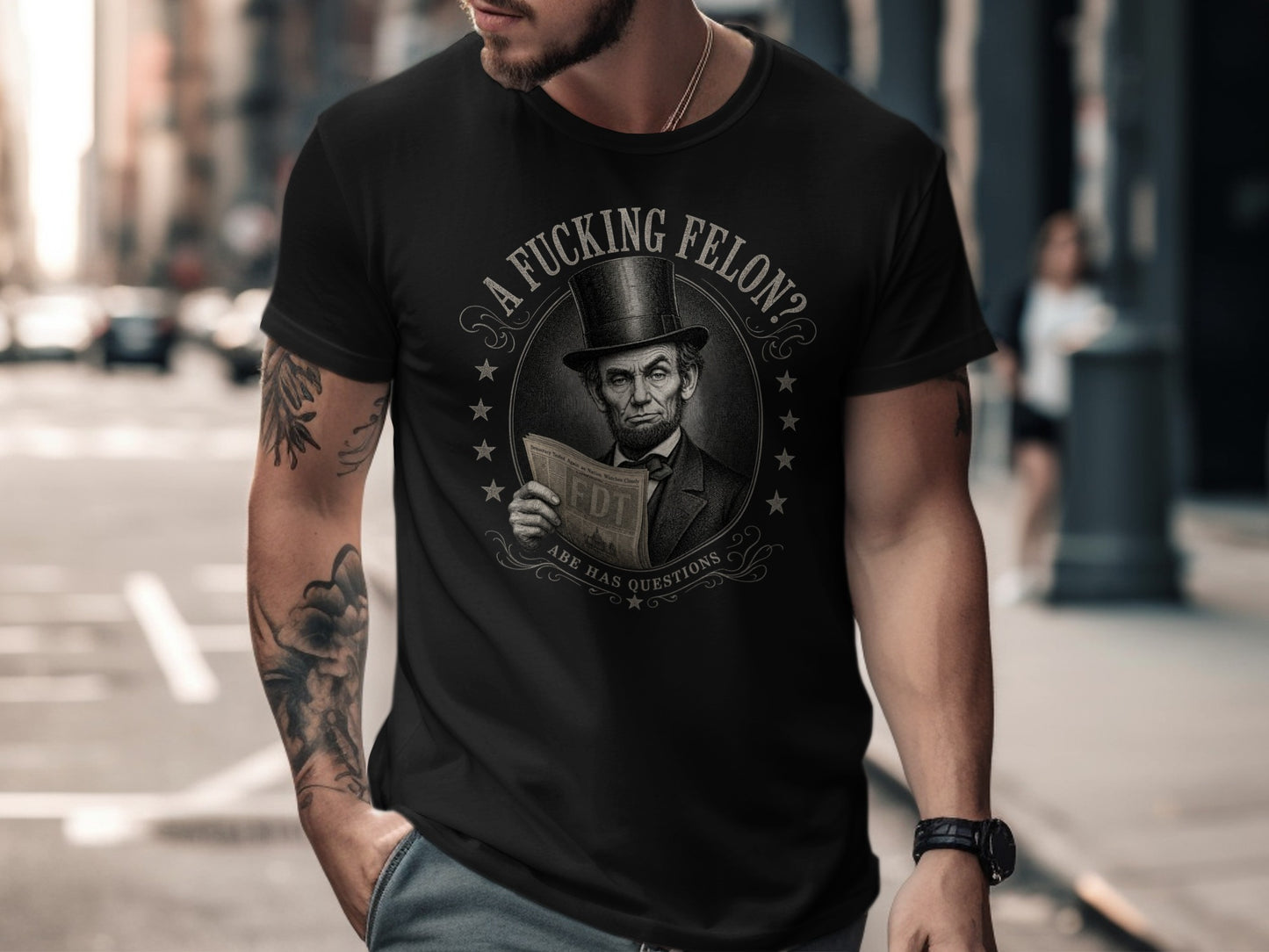 Black t-shirt with Abraham Lincoln holding a newspaper asking "A Fucking Felon?"