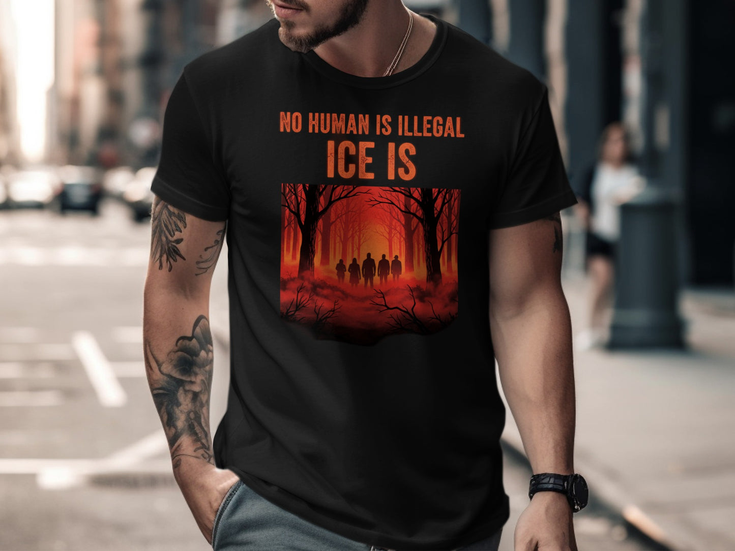 Black t-shirt with "NO HUMAN IS ILLEGAL" and "ICE IS" text and forest silhouette.