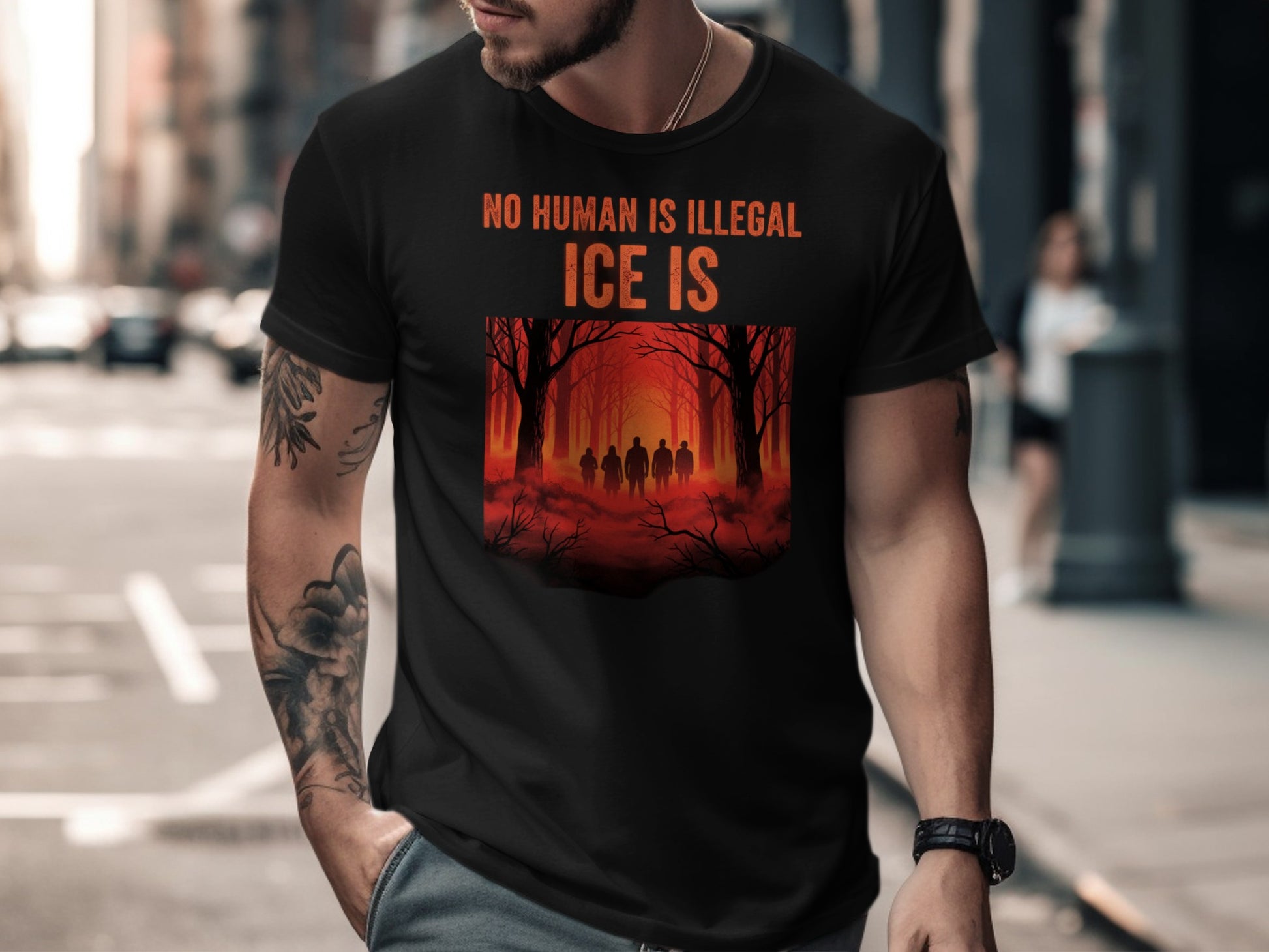 Black t-shirt with "NO HUMAN IS ILLEGAL" and "ICE IS" text and forest silhouette.