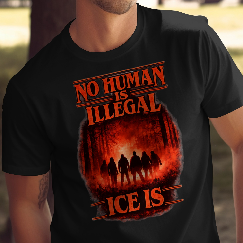Black t-shirt with "No Human is Illegal" and a forest scene.