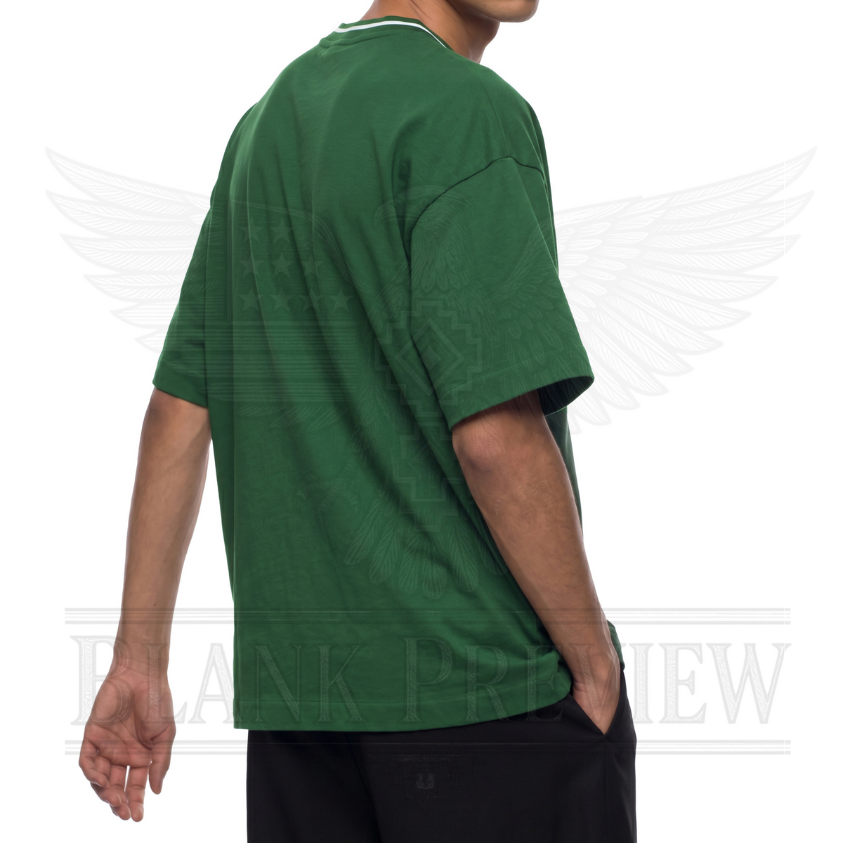 A person wearing a green t-shirt is standing against a white background with a graphic design.