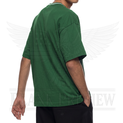 A person wearing a green t-shirt is standing against a white background with a graphic design.