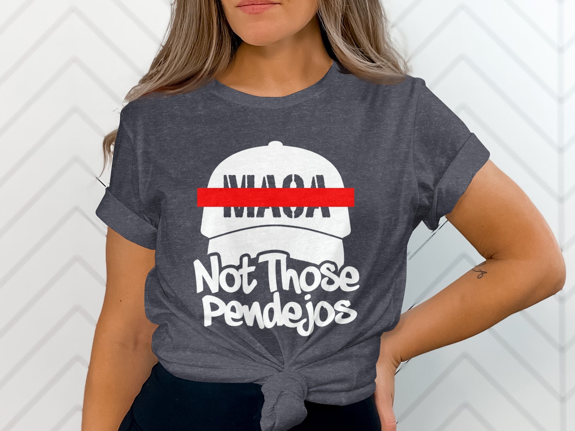 Dark grey t-shirt with white text and a red bar across a white hat graphic.