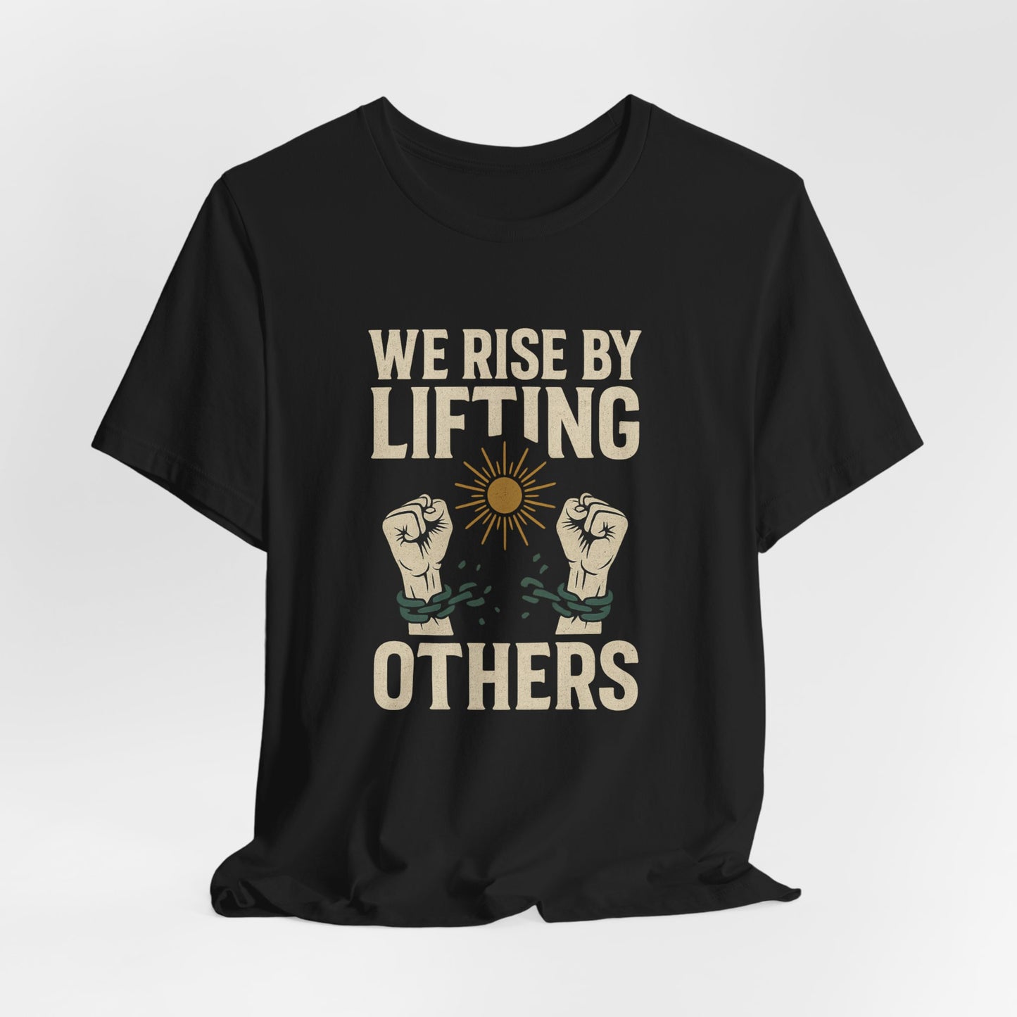 Black t-shirt with "WE RISE BY LIFTING OTHERS" and broken chain imagery.