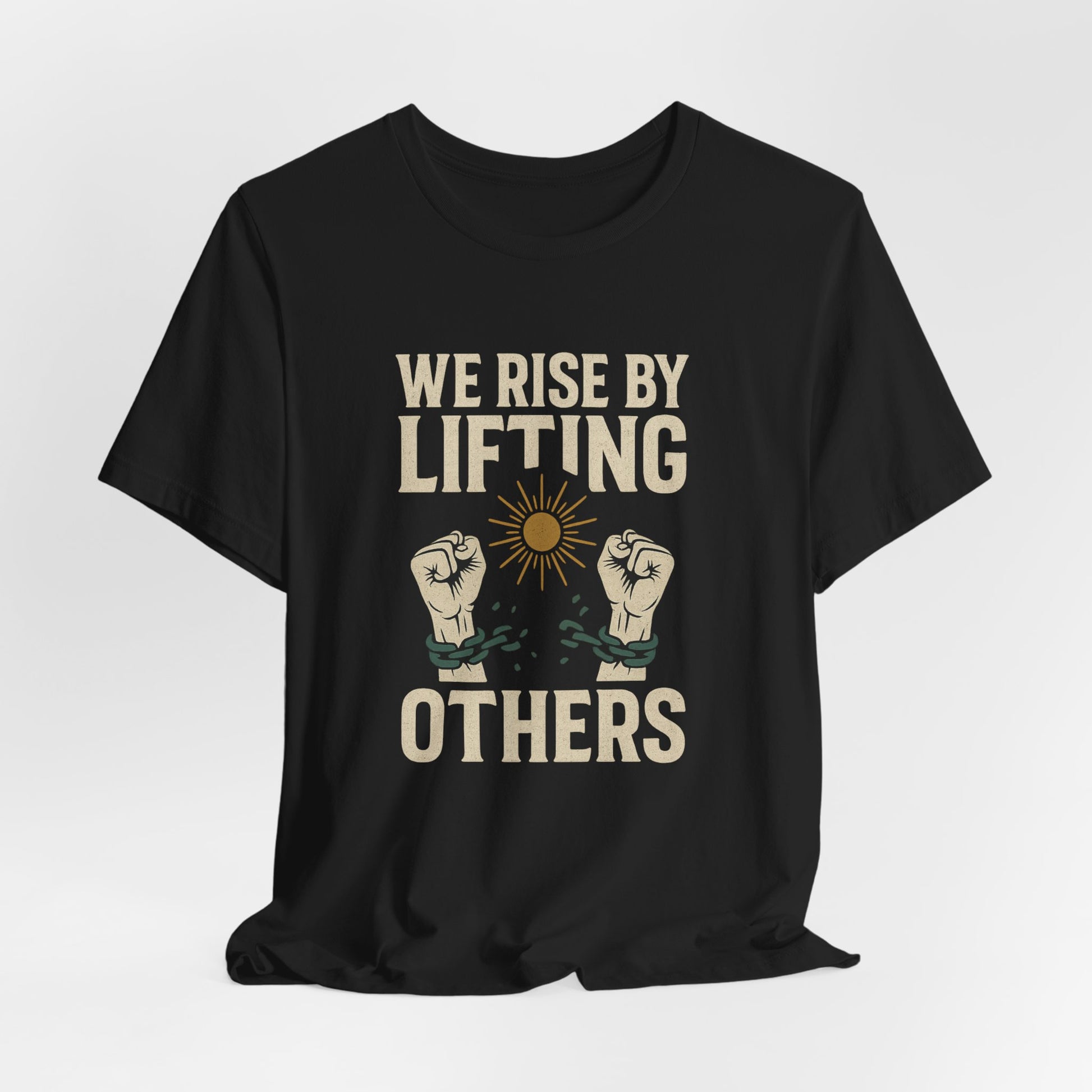 Black t-shirt with "WE RISE BY LIFTING OTHERS" and broken chain imagery.