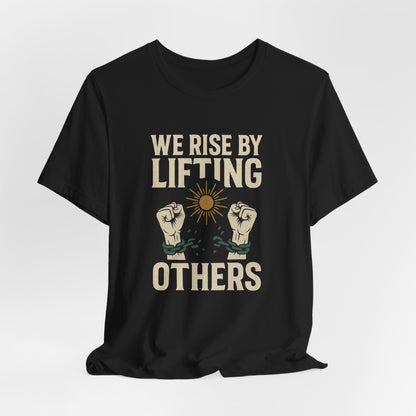 Black t-shirt with "WE RISE BY LIFTING OTHERS" and broken chain imagery.