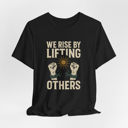 Black t-shirt with "WE RISE BY LIFTING OTHERS" and broken chain imagery.