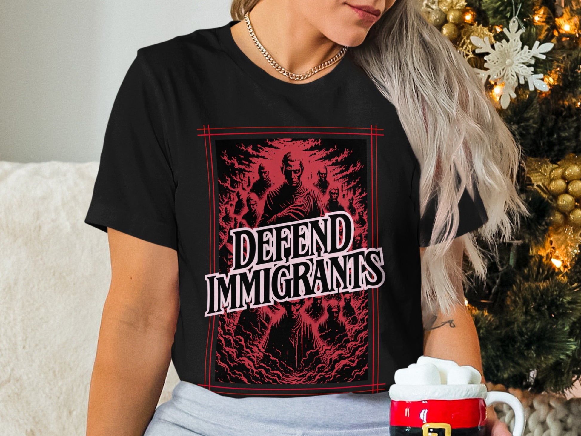 Black t-shirt with "DEFEND IMMIGRANTS" text and dark, smoky figures.