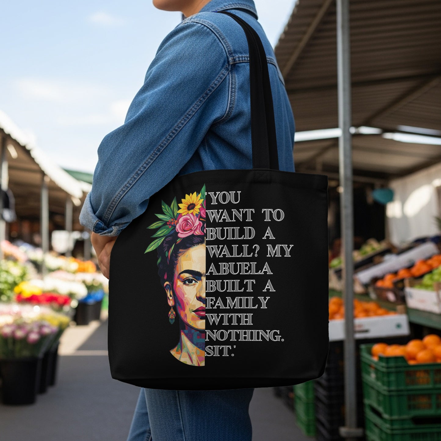 Black tote bag with Frida Kahlo portrait and quote about family.