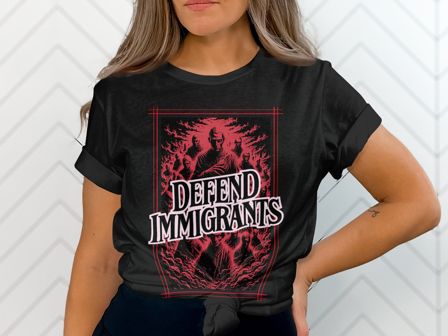 Black t-shirt with red graphic of people and text "DEFEND IMMIGRANTS".