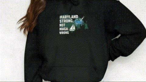 A person wearing a black hoodie with a graphic design on it.