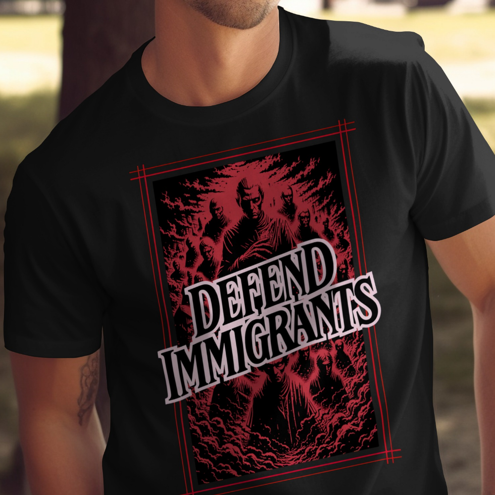 Black t-shirt with red-bordered graphic of people and text "DEFEND IMMIGRANTS".