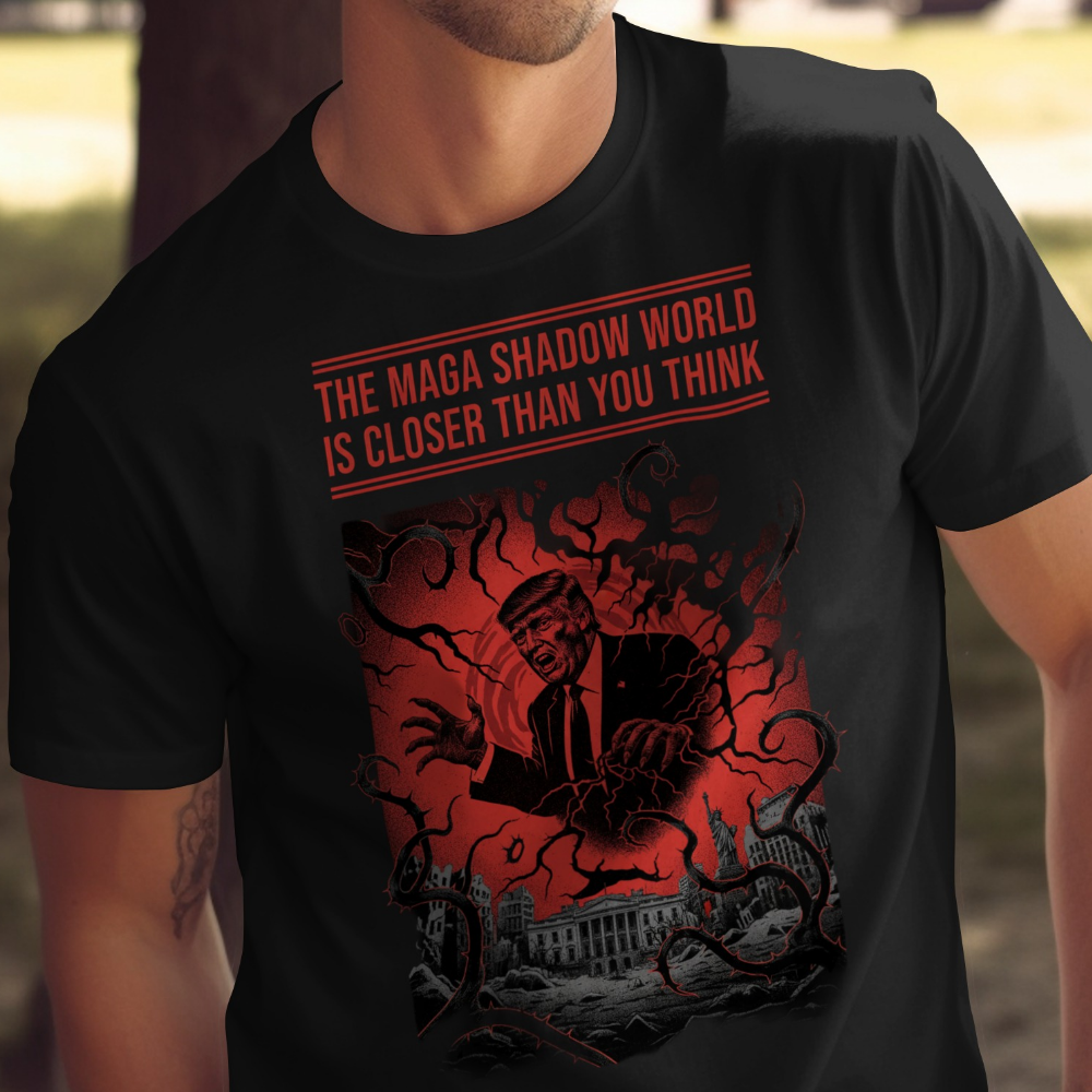 T-shirt graphic features a shadowy silhouette of Donald Trump with the text "The Maga Shadow World Is Closer Than You Think."
