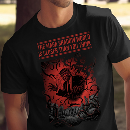 T-shirt graphic features a shadowy silhouette of Donald Trump with the text "The Maga Shadow World Is Closer Than You Think."