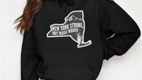 A person wearing a black hoodie with a graphic design on it.