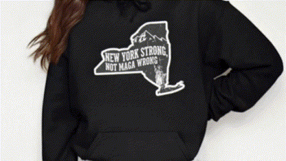 A person wearing a black hoodie with a graphic design on it.